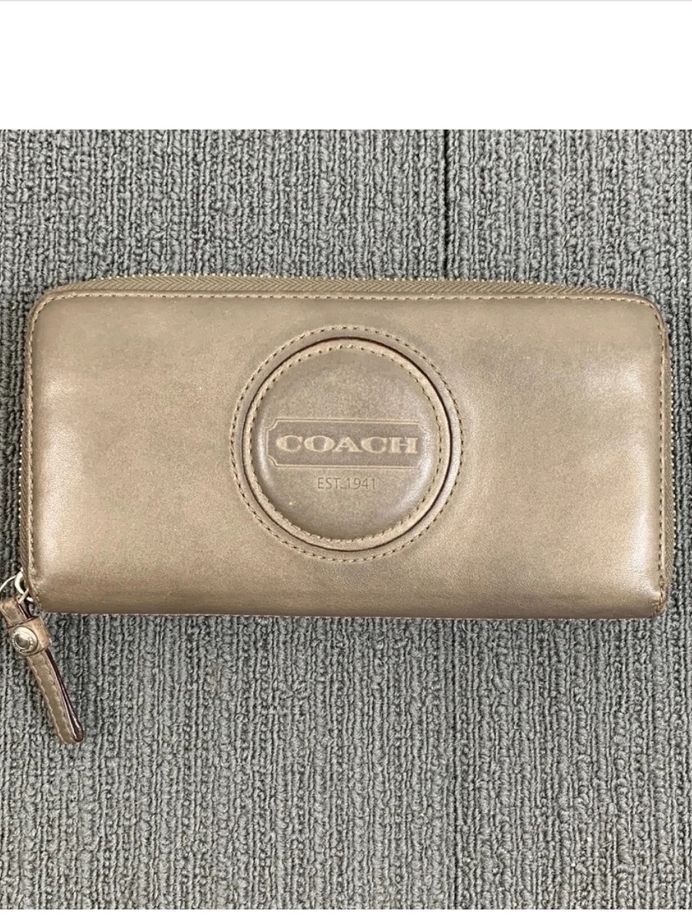 COACH Metallic Taupe Zip-Around Wallet with "COACH EST. 1941" logo on the front.